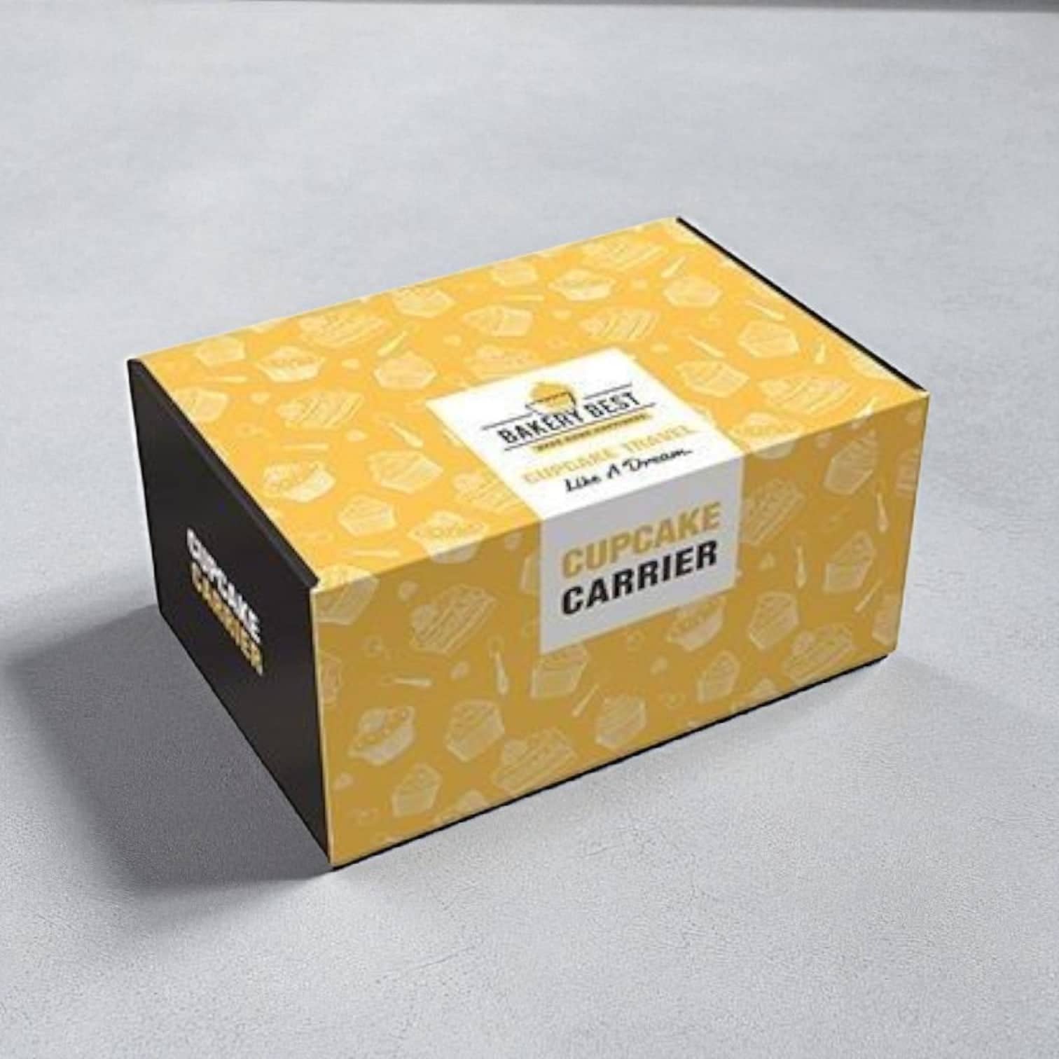 PackSmart yellow patterned bakery box with a cupcake carrier label on a grey surface.