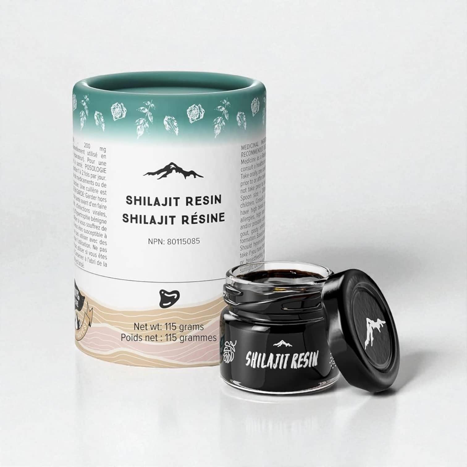 PackSmart white and teal paper tube for Shilajit resin with a mountain illustration, standing next to a small black jar of the resin.