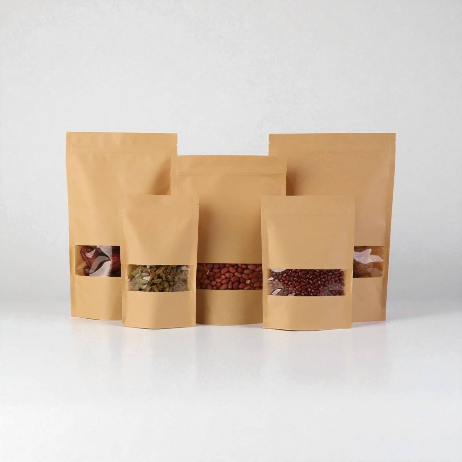PackSmart row of kraft zip-lock stand-up pouches in three sizes with clear windows showing dried food.
